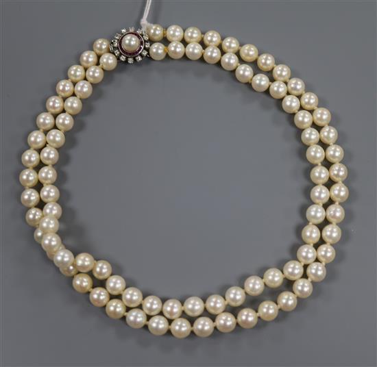 A double strand cultured pearl necklace, with diamond and gem set circular clasp, 42cm.